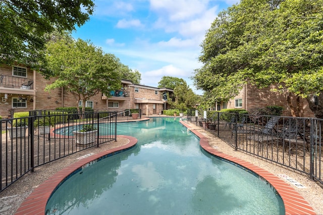 community pool featuring fence