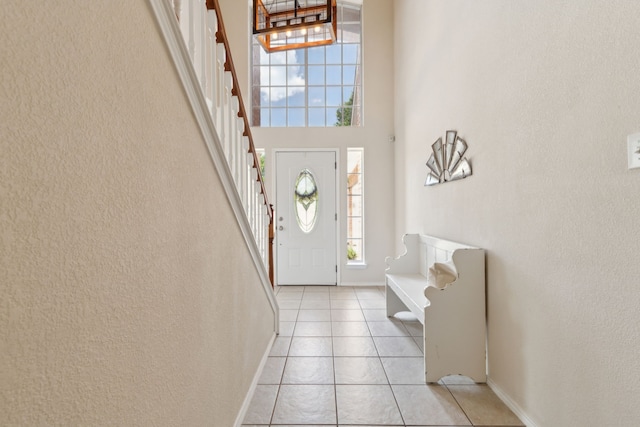 1016 Hidden Creek Ct, Allen, TX 75002 - foyer with stairway, light tile patterned flooring, a towering ceiling, and baseboards