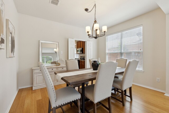 1016 Hidden Creek Ct, Allen, TX 75002 - dining area with a chandelier, light wood-style flooring, baseboards, and arched walkways