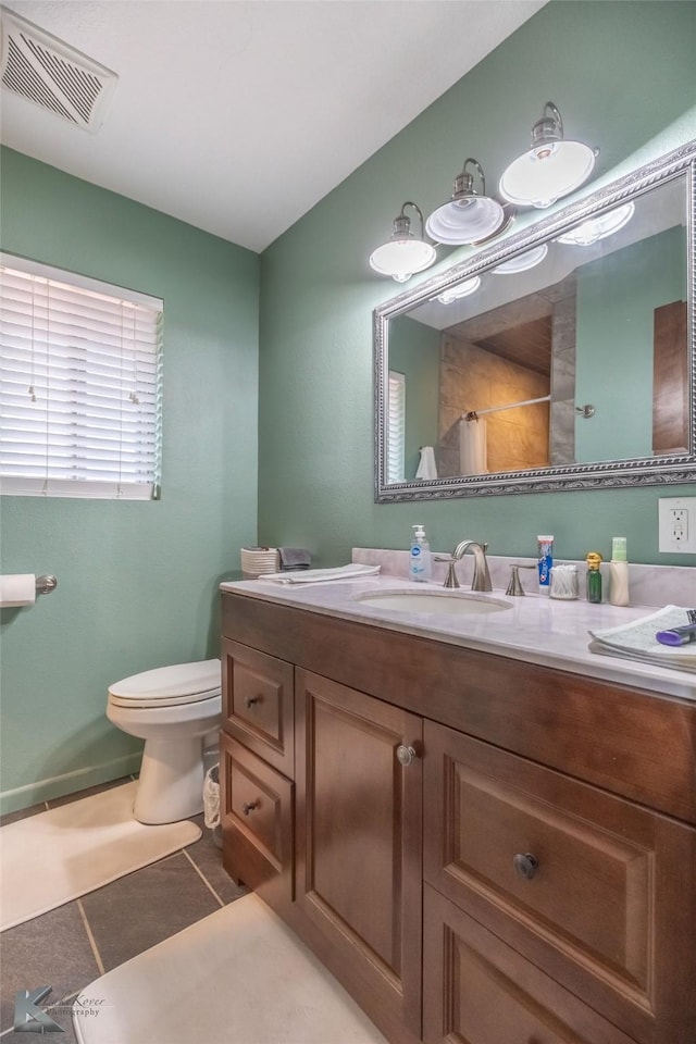 649 Westwood Dr, Abilene, TX 79603 - bathroom with toilet, vanity, tile patterned flooring, and a shower