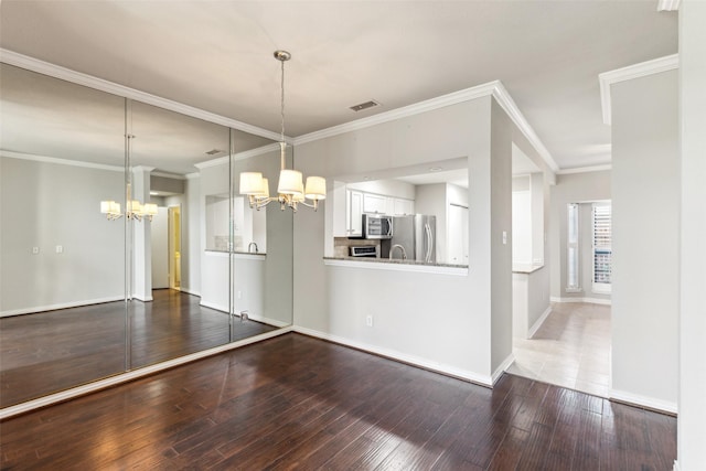 14333 Preston Rd Unit 1103, Dallas, TX 75254 - unfurnished dining area with a chandelier, wood-type flooring, ornamental molding, and baseboards