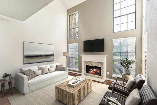 14333 Preston Rd Unit 1103, Dallas, TX 75254 - living room featuring light wood-style floors, healthy amount of natural light, a tiled fireplace, high vaulted ceiling, and a textured wall