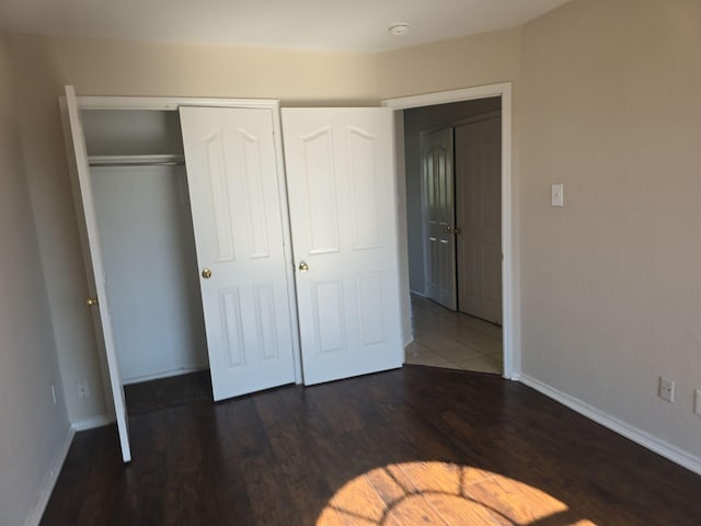 8313 French Quarter Ln, Fort Worth, TX 76123 - unfurnished bedroom featuring wood finished floors, baseboards, and a closet