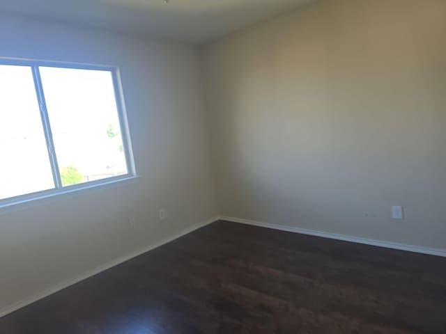 8313 French Quarter Ln, Fort Worth, TX 76123 - empty room with dark wood-type flooring and baseboards