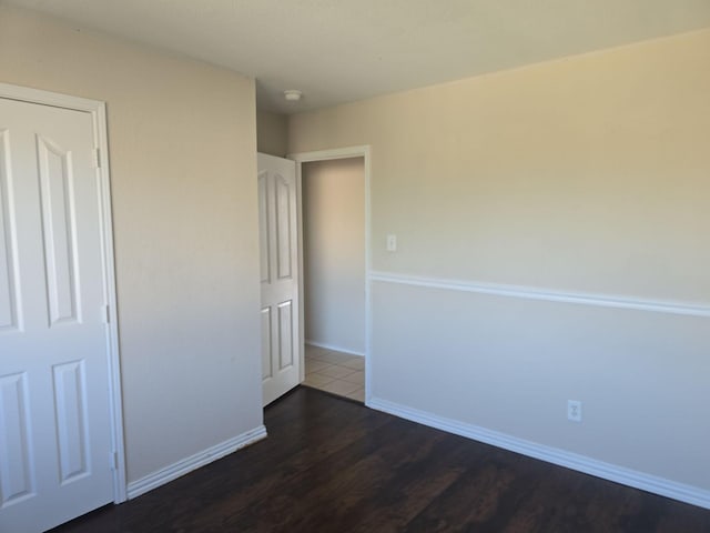 8313 French Quarter Ln, Fort Worth, TX 76123 - unfurnished bedroom with dark wood-style floors and baseboards