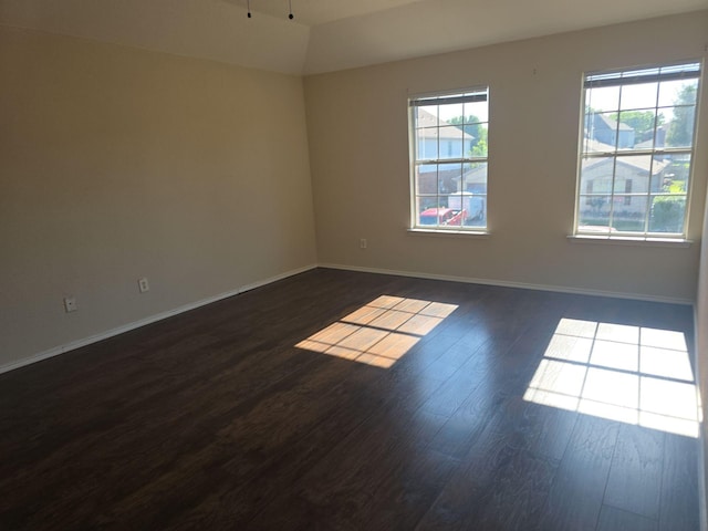 8313 French Quarter Ln, Fort Worth, TX 76123 - spare room featuring dark wood-style flooring, baseboards, and lofted ceiling