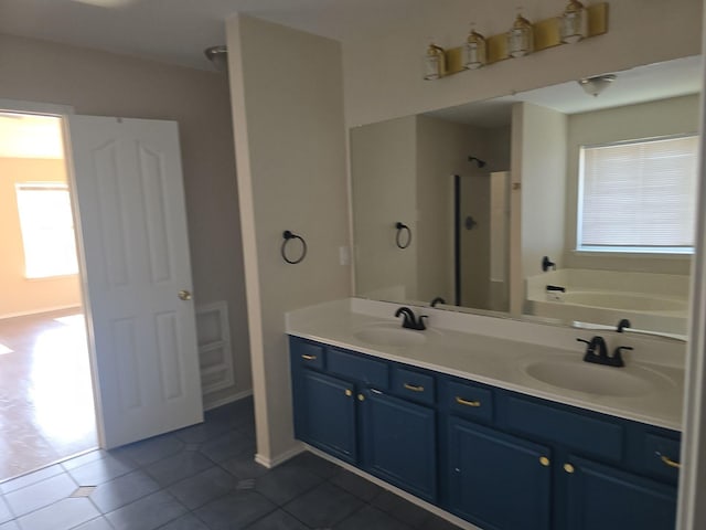 8313 French Quarter Ln, Fort Worth, TX 76123 - bathroom featuring tile patterned flooring, a stall shower, a bath, double vanity, and baseboards