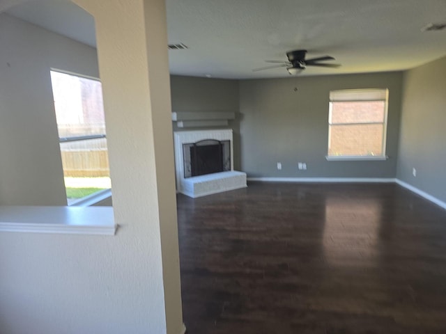 8313 French Quarter Ln, Fort Worth, TX 76123 - unfurnished living room featuring a ceiling fan, wood finished floors, a fireplace, and baseboards