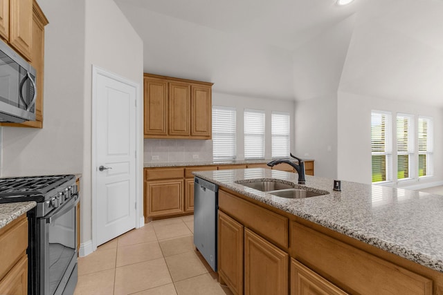 1105 Pigeon Hawk Dr, Little Elm, TX 75068 - kitchen with appliances with stainless steel finishes, a sink, light stone countertops, light tile patterned floors, and vaulted ceiling