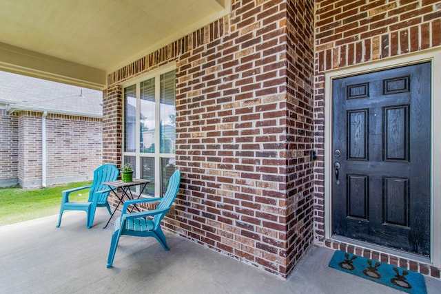 1105 Pigeon Hawk Dr, Little Elm, TX 75068 - property entrance featuring brick siding and a porch