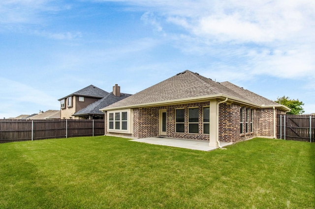 1105 Pigeon Hawk Dr, Little Elm, TX 75068 - back of property featuring brick siding, a patio area, and roof with shingles