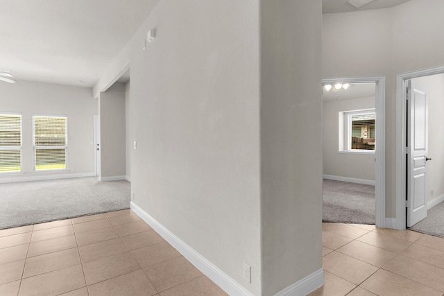 1105 Pigeon Hawk Dr, Little Elm, TX 75068 - corridor featuring light colored carpet, light tile patterned floors, and baseboards