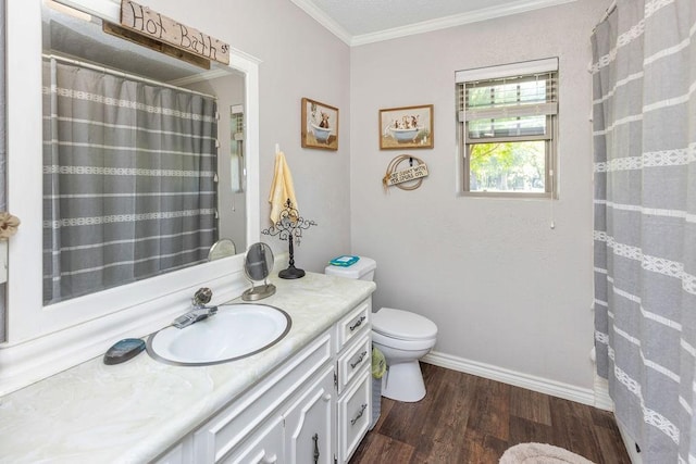 9216 Fm 195, Paris, TX 75462 - full bath with ornamental molding, wood finished floors, baseboards, vanity, and toilet