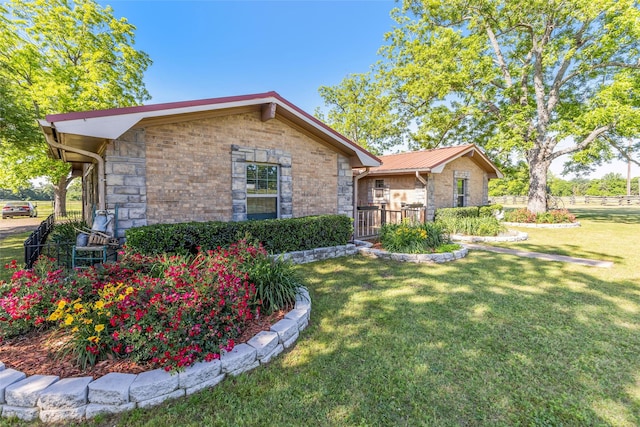 9216 Fm 195, Paris, TX 75462 - view of front facade with stone siding, a front lawn, and metal roof