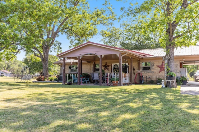 9216 Fm 195, Paris, TX 75462 - view of front of property featuring a front yard, metal roof, stone siding, and a porch