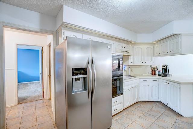 5808 Arbor Valley Dr, Arlington, TX 76016 - kitchen with stainless steel refrigerator with ice dispenser, a textured ceiling, light tile patterned flooring, light countertops, and cooktop
