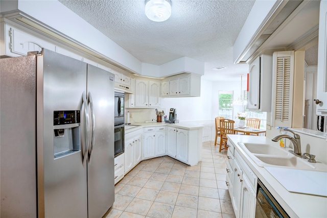 5808 Arbor Valley Dr, Arlington, TX 76016 - kitchen featuring stainless steel refrigerator with ice dispenser, a sink, a textured ceiling, light countertops, and light tile patterned floors