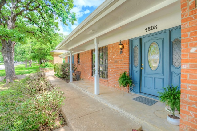 5808 Arbor Valley Dr, Arlington, TX 76016 - view of exterior entry featuring brick siding and covered porch
