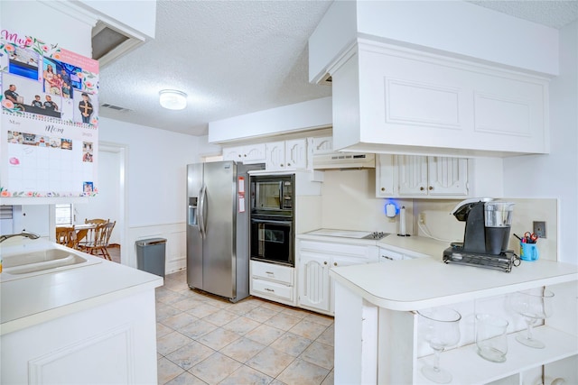 5808 Arbor Valley Dr, Arlington, TX 76016 - kitchen with black appliances, a sink, a peninsula, a textured ceiling, and light countertops