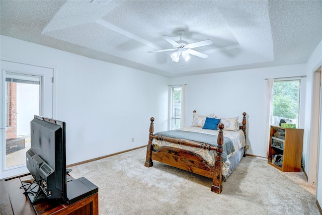 5808 Arbor Valley Dr, Arlington, TX 76016 - bedroom featuring a textured ceiling, carpet flooring, a tray ceiling, baseboards, and ceiling fan