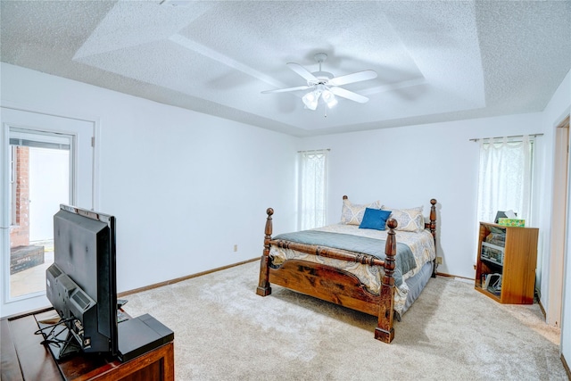 5808 Arbor Valley Dr, Arlington, TX 76016 - carpeted bedroom with a textured ceiling, multiple windows, a raised ceiling, baseboards, and ceiling fan