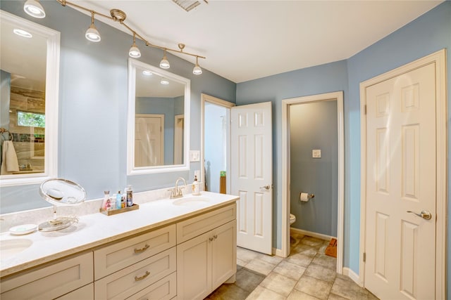 5808 Arbor Valley Dr, Arlington, TX 76016 - full bath featuring double vanity, toilet, and baseboards