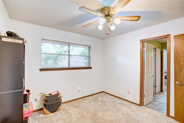 5808 Arbor Valley Dr, Arlington, TX 76016 - unfurnished bedroom featuring carpet floors, a textured ceiling, baseboards, and a ceiling fan