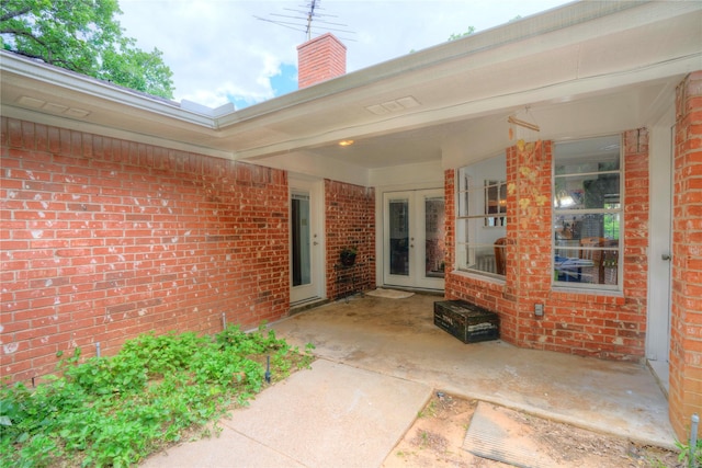 5808 Arbor Valley Dr, Arlington, TX 76016 - entrance to property featuring french doors, brick siding, and a chimney