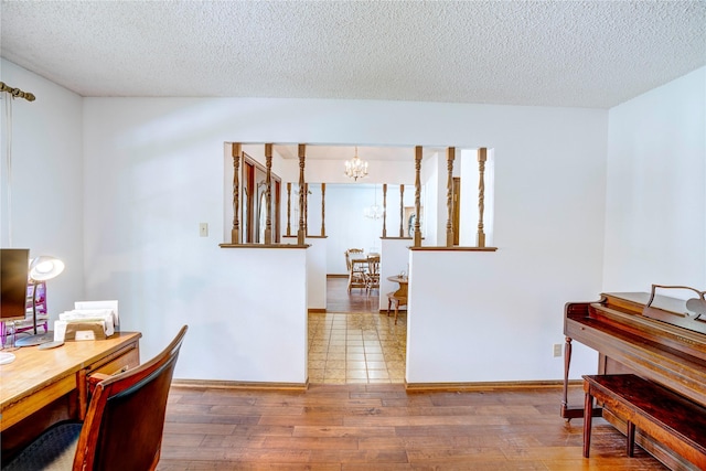 5808 Arbor Valley Dr, Arlington, TX 76016 - office area with a chandelier, a textured ceiling, wood finished floors, and baseboards