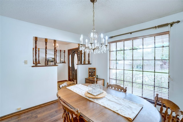 5808 Arbor Valley Dr, Arlington, TX 76016 - dining area featuring wood finished floors, a chandelier, baseboards, and a textured ceiling