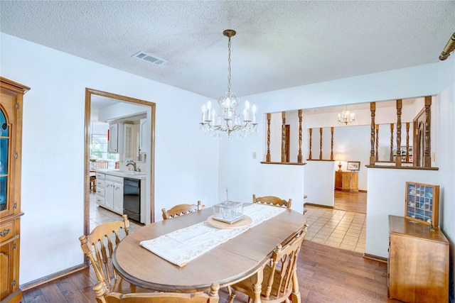 5808 Arbor Valley Dr, Arlington, TX 76016 - dining area with a chandelier, wood-type flooring, and a textured ceiling
