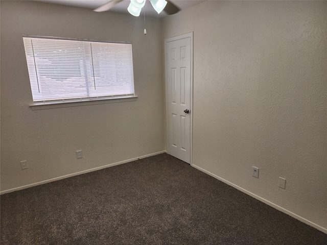 2614 Santa Barbara Dr, Grand Prairie, TX 75052 - empty room with ceiling fan, dark colored carpet, and baseboards