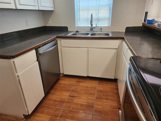 2614 Santa Barbara Dr, Grand Prairie, TX 75052 - kitchen featuring stainless steel appliances, a sink, a textured wall, and white cabinetry