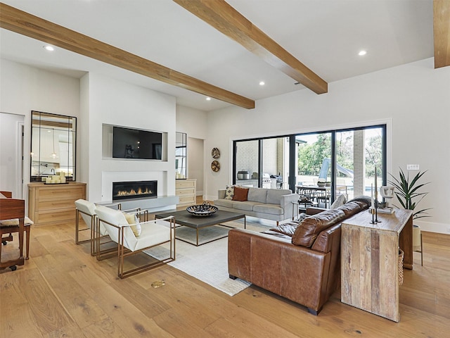 2015 Honey Ln, Celina, TX 75009 - living room with beam ceiling, a glass covered fireplace, light wood-style floors, recessed lighting, and baseboards