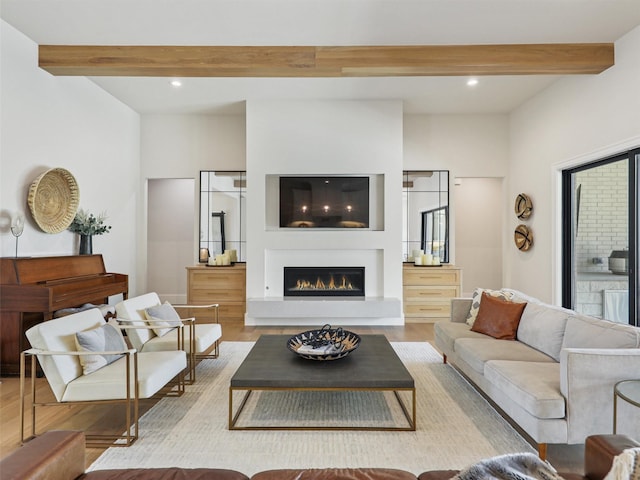 2015 Honey Ln, Celina, TX 75009 - living area featuring beam ceiling, wood finished floors, a warm lit fireplace, and recessed lighting