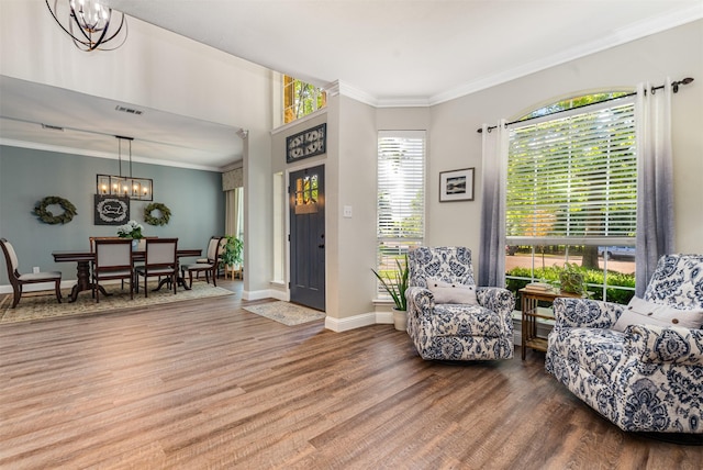 4 Raintree Ct, Mansfield, TX 76063 - living area featuring wood finished floors, a chandelier, ornamental molding, and baseboards