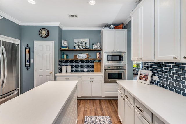 4 Raintree Ct, Mansfield, TX 76063 - kitchen with appliances with stainless steel finishes, tasteful backsplash, light countertops, ornamental molding, and white cabinets
