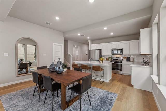 10645 Nokose St, Fort Worth, TX 76179 - dining area featuring light wood-style floors, recessed lighting, baseboards, and stairs