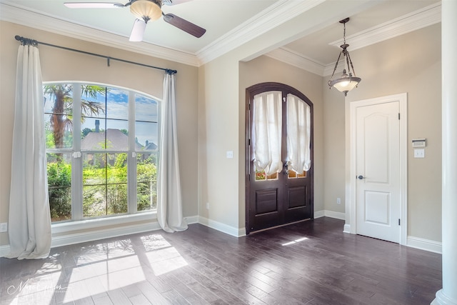 foyer with ornamental molding, wood finished floors, ceiling fan, and baseboards