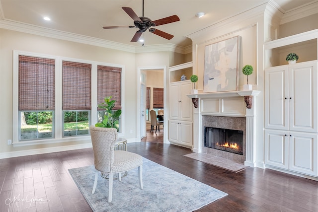 living area with dark wood-style flooring, crown molding, a ceiling fan, a high end fireplace, and recessed lighting