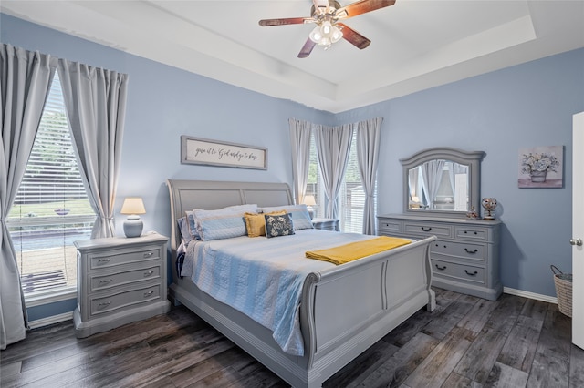 1701 Travis Ct, Allen, TX 75002 - bedroom with a tray ceiling, dark wood-style floors, baseboards, and ceiling fan