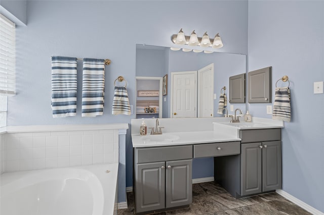 1701 Travis Ct, Allen, TX 75002 - bathroom featuring double vanity, a garden tub, and baseboards