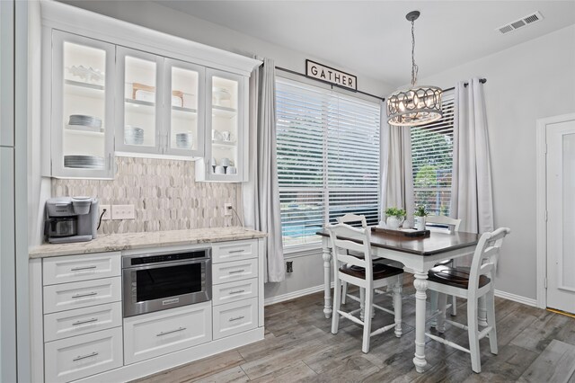 1701 Travis Ct, Allen, TX 75002 - dining area with a chandelier, plenty of natural light, and wood finished floors