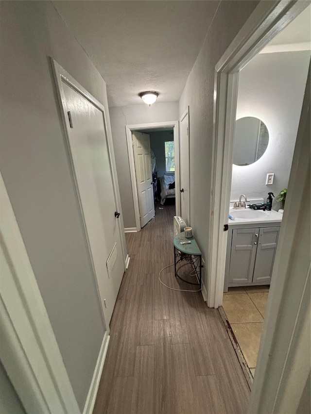 4233 Ridgecrest Cir, Lake Worth, TX 76135 - hall featuring a sink, wood finished floors, and baseboards