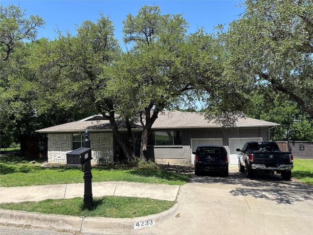 4233 Ridgecrest Cir, Lake Worth, TX 76135 - view of front of property with a garage, concrete driveway, and stone siding