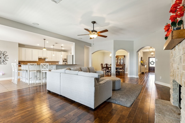 1250 Amistad Dr, Prosper, TX 75078 - living area featuring arched walkways, wood-type flooring, ceiling fan, and baseboards