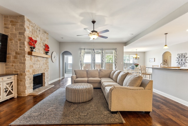 1250 Amistad Dr, Prosper, TX 75078 - living area featuring arched walkways, dark wood finished floors, baseboards, and ceiling fan