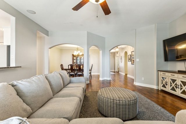 1250 Amistad Dr, Prosper, TX 75078 - living room with arched walkways, a ceiling fan, dark wood-style floors, and a chandelier