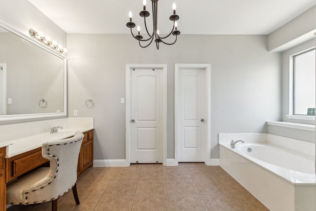 full bathroom with vanity, a chandelier, a garden tub, tile patterned flooring, and baseboards
