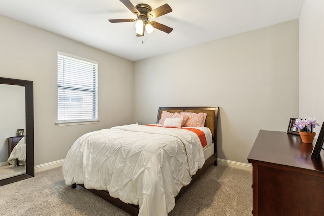 bedroom featuring carpet floors, baseboards, and ceiling fan